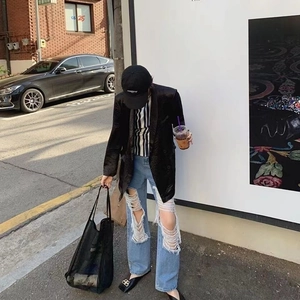 Stylish black mesh tote bag paired with an oversized blazer and ripped jeans for casual look