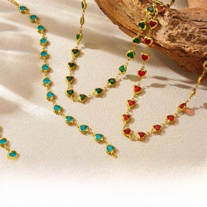 Detailed close-up of colorful heart-shaped crystal pendants on elegant gold chains