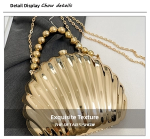 Detail of shell-shaped gold evening clutch with radial relief texture and beaded handle