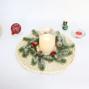 Christmas candle wreath with green pine needles, red berries, and natural pinecones