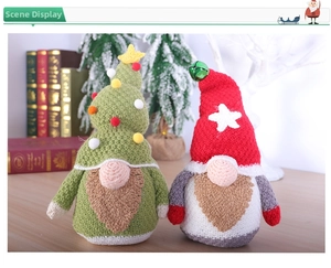 Close-up of knit Christmas gnomes with stars and bells in a cozy winter holiday setting