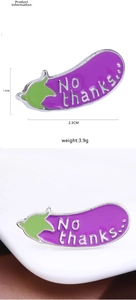 Macro detail of eggplant enamel pin with 'No thanks' text and product dimensions