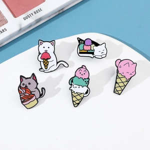 Detail view of five cute cartoon cat ice cream enamel pins on a blue background