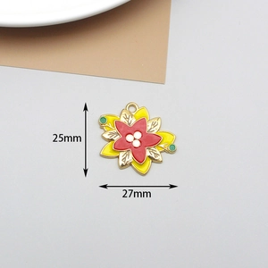 Detailed size view of yellow and red floral enamel jewelry charm measuring 25mm by 27mm