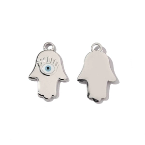 Macro detail of silver Hamsa Hand pendants with blue evil eye inlay and polished back