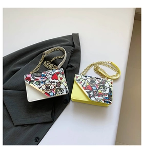 Detail showing graffiti print small square bags with gold chains and asymmetric flaps
