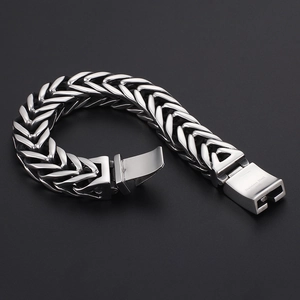 Macro detail of 316L stainless steel clasp with engraved texture on a chunky men's bracelet