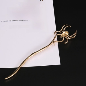 Vintage golden spider hair pin with minimalist irregular metal design on card