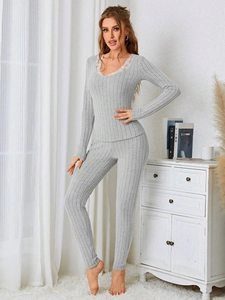 Detail of grey ribbed pajama set with elegant white lace trim on the deep V-neckline