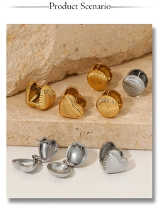Detail of heart and round earrings in gold and silver with textured shell finish