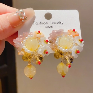 Detail of floral earrings with S925 silver needles, resin petals and faux pearls