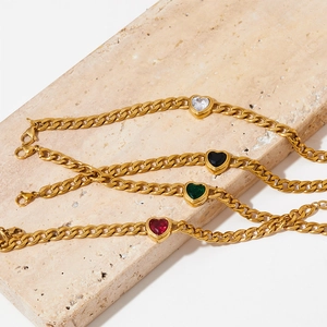Golden Cuban chain jewelry set with colorful heart zircon pendants on travertine stone