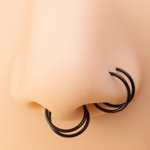 Double-layered black stainless steel spiral nose ring shown on a model for piercing jewelry
