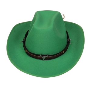 Detailed view of green felt cowboy hat with metal bull head and studded decorative band