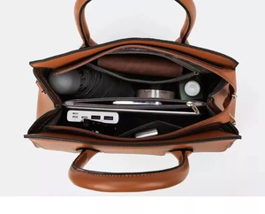 Interior view showing the large capacity and multiple compartments of the brown tote bag