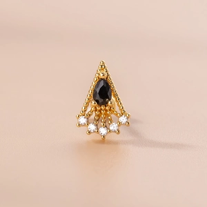 Close-up of gold stud earring with black teardrop zircon and white round crystals