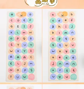 Detail of colorful macaron letter stickers with cute cartoon puppy for DIY journals