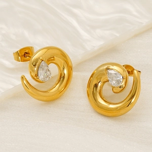 French style 18K gold plated spiral earrings with waterdrop zircon stones on marble base