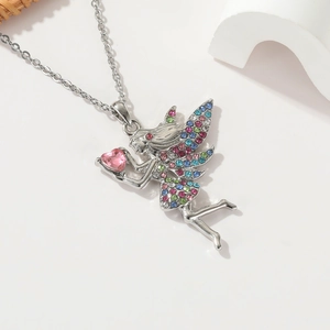Detail of fairy pendant with multicolor rhinestones and pink heart gem on silver chain