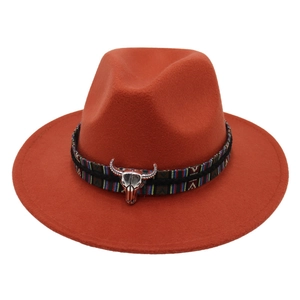 Burnt orange fedora hat with ethnic woven band and silver bull head metal ornament