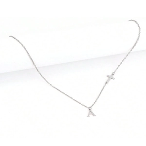 Detailed view of silver minimalist necklace with letter A and side cross pendants