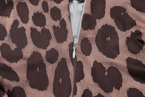 Detail of leopard print dress fabric showing seamless invisible zipper and texture