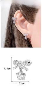 Detail view of silver bow stud earring with star zircon pendant and precise dimensions