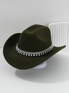 Detail of dark green western cowboy hat featuring silver chains and sparkling rhinestones