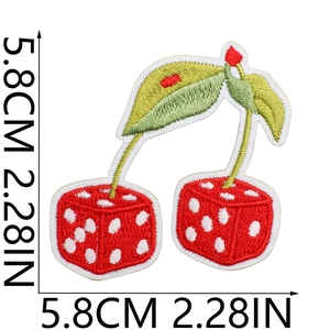 Close-up of cherry dice embroidery patch showing 5.8cm size and green leaf details