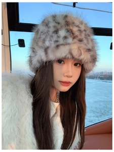 Close-up of leopard print plush bucket hat texture with soft winter faux fur material