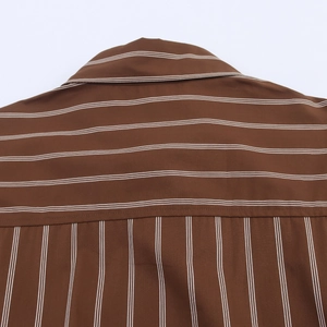 Detail of the back collar and shoulder stitching on a brown striped shirt