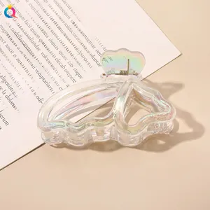 Macro view of iridescent butterfly hair claw with clear finish and gold metal spring