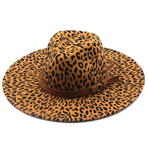 Stylish leopard print fedora hat with wide brim and brown leather tassel band detail