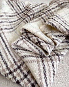 Close-up of beige and brown plaid cashmere-like scarf with soft thick woven texture