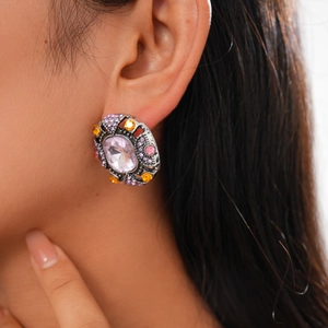 Vintage geometric silver studs with purple center stone and multicolor crystals on model