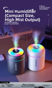 Close-up of portable desktop humidifiers with vibrant RGB ring lighting on wooden desk