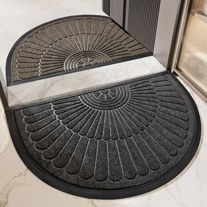 Semi-circle rubber doormats in brown and grey with radial fan-shaped groove patterns