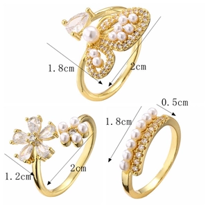 Detailed view of gold rings featuring butterfly and flower designs with size annotations