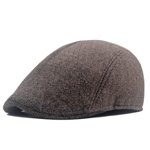 Detailed close-up of dark brown wool blend flat cap showing premium stitching and texture