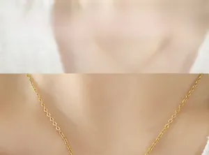 Close-up of gold titanium steel chain necklace with sparkling zircon pendant for women