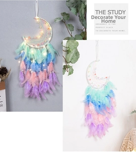 Detailed view of handmade moon dream catcher with colorful feathers and LED lights