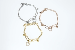 Three chain bracelets in gold, silver, and rose gold with heart pendants and K18 hallmark
