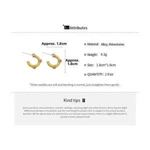 Detail showing dimensions of yellow C-shaped hoop earrings with rhinestones and silver needles
