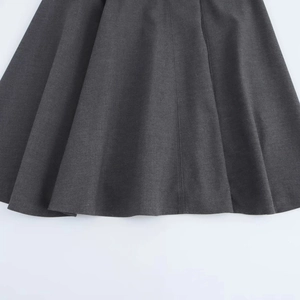 Close-up of deep gray midi dress showing fine fabric texture and neat hemline stitching