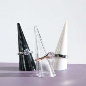 Transparent and solid cone ring stands showcasing silver and rose gold zircon rings