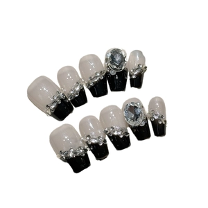 Elegant black ombre press-on nails with sparkling rhinestones and large crystal accents