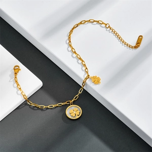 Detailed macro view of gold-plated stainless steel chain with a clover pendant