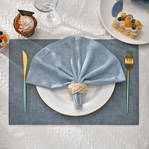 Blue woven placemat with coordinated rope napkin ring for elegant table settings