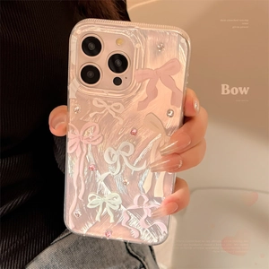 Detailed view of clear iPhone case with pink bows and sparkling crystal rhinestones