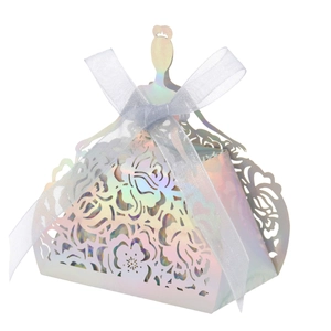 Detail of laser-cut hollow dress-shaped gift box in iridescent white with a white ribbon
